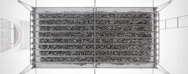 Kristina Matousch, Still Life Production, 2013, scaffolding, steel planks, clay, 3 x 6 x 4 m. During the performance on April 4th, the artist trampled trampled two tonnes of clay through the holes of the platform.