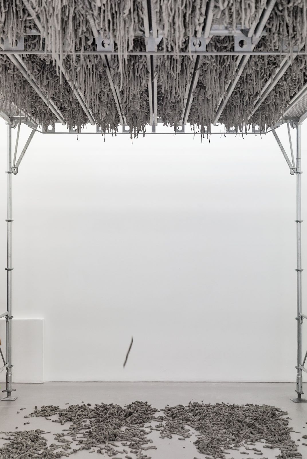 Still Life Production, 2013, scaffolding, steel planks, clay, 3 x 6 x 4 m. During the performance in Galleri Riis, Stockholm, 2013, the artist trampled three tons of clay through the holes of the platform.